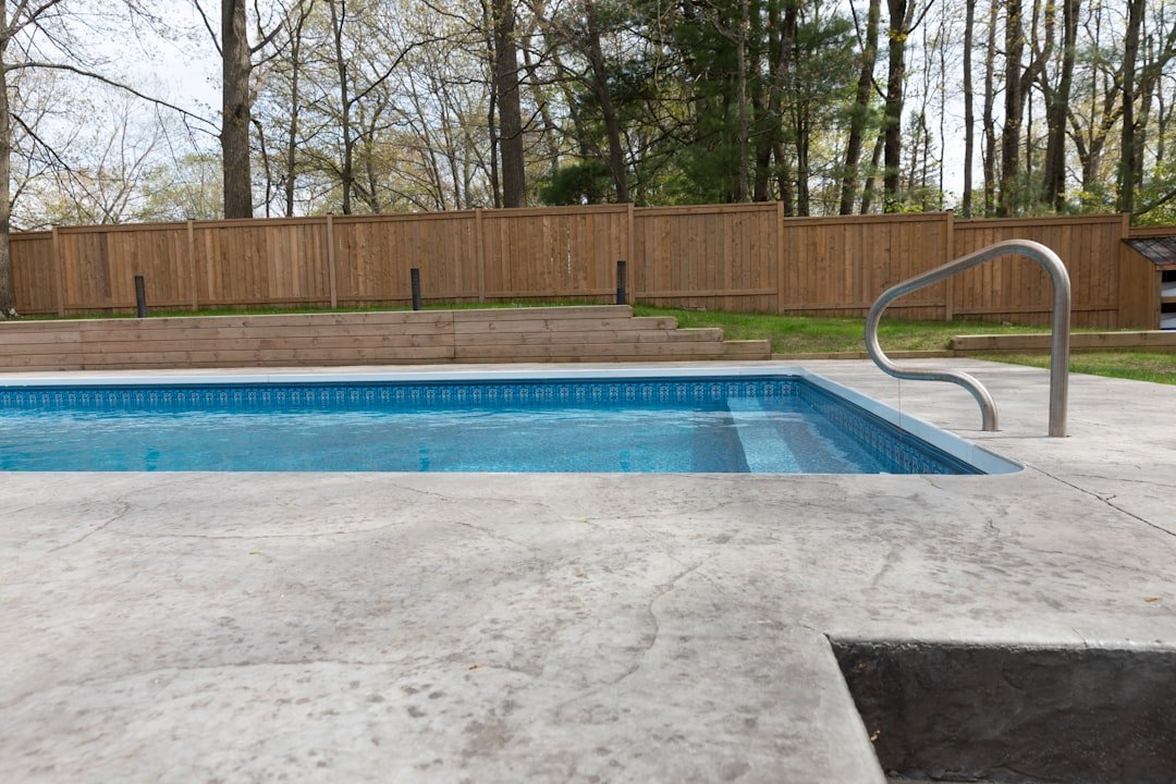 Professional pool contractor inspecting pool construction